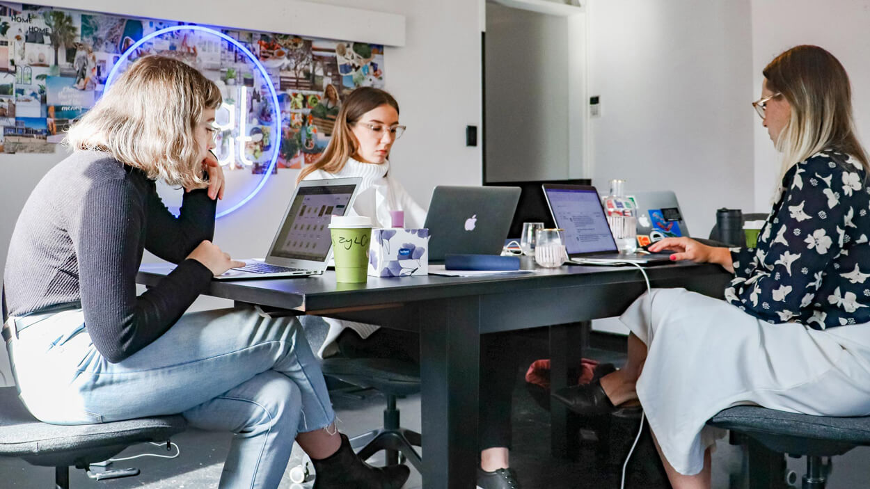 Design and development team collaborating on web and mobile app interfaces